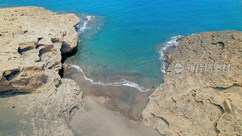 Aerial view of the hidden cove beach "La Rajita" at the natural reserve of "Monta?a Pelada" in Tenerife (Canary Islands). Drone shot